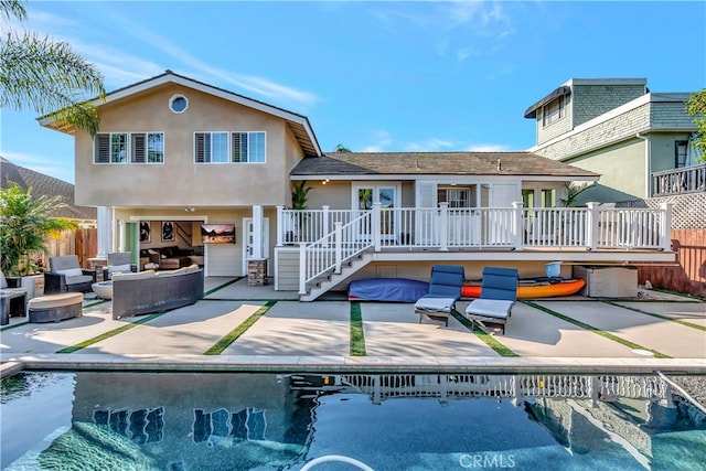 rear view of house with outdoor lounge area and a patio area