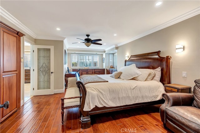 bedroom with ornamental molding, ceiling fan, and hardwood / wood-style floors