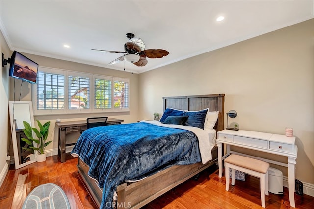 bedroom with wood-type flooring, ornamental molding, and ceiling fan