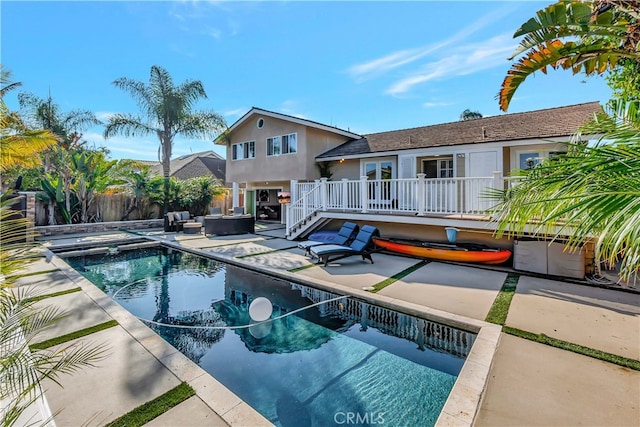 view of pool with a wooden deck and a patio area