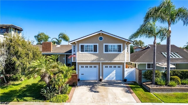 view of front of home with a front yard and a garage