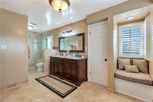 bathroom featuring walk in shower, vanity, toilet, and tile patterned floors