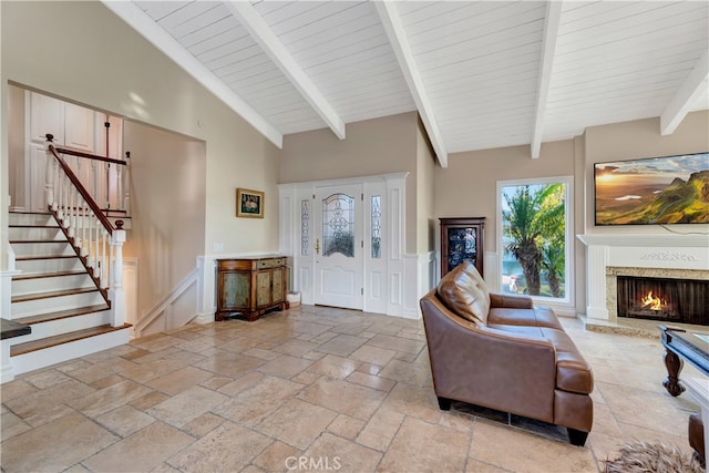 foyer entrance with beamed ceiling and high vaulted ceiling