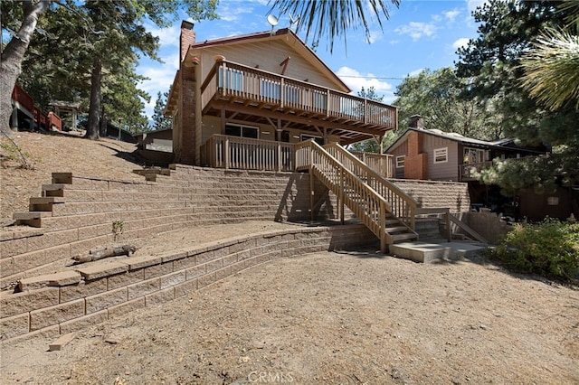 rear view of property featuring a wooden deck