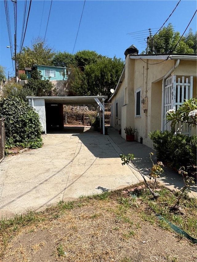 view of side of home with a carport