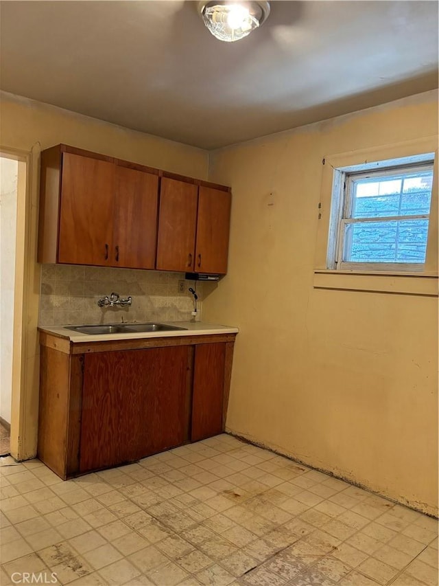 kitchen featuring tasteful backsplash and sink