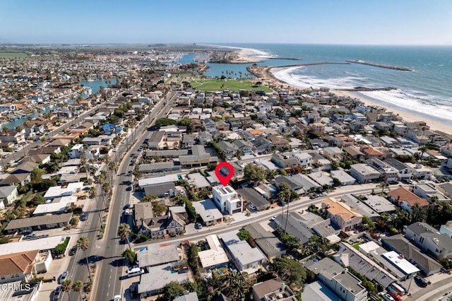 drone / aerial view featuring a water view and a beach view