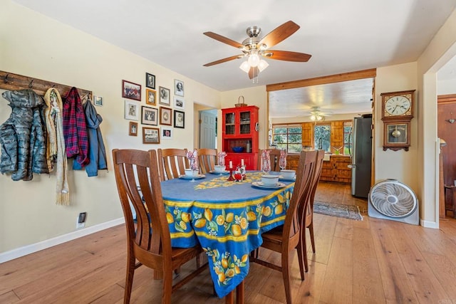 dining room with ceiling fan and light hardwood / wood-style flooring