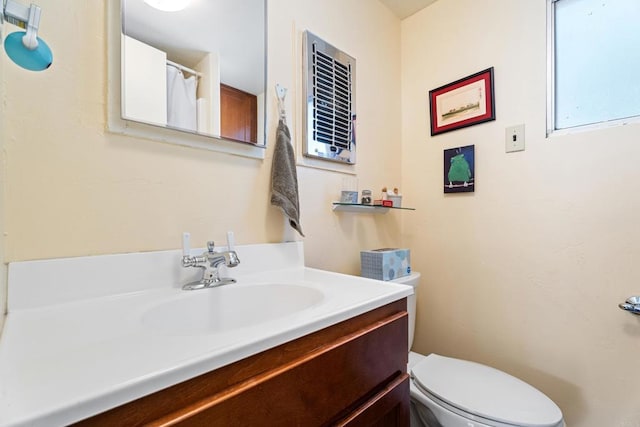 bathroom with toilet and vanity