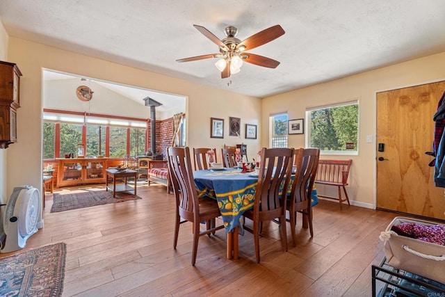 dining area with ceiling fan, a textured ceiling, and hardwood / wood-style flooring