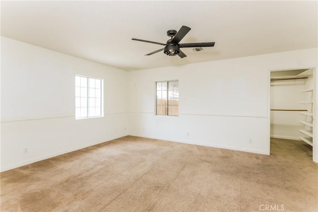 carpeted empty room featuring ceiling fan