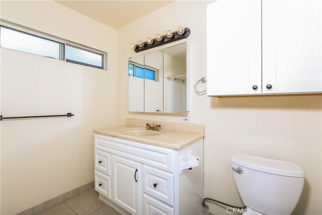 bathroom with tile patterned flooring, vanity, and toilet