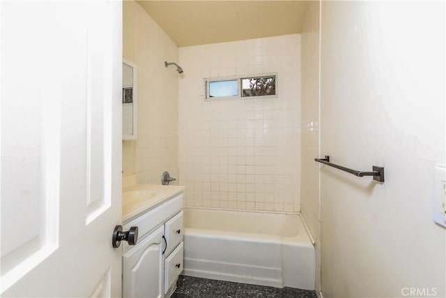 bathroom with vanity and tiled shower / bath combo