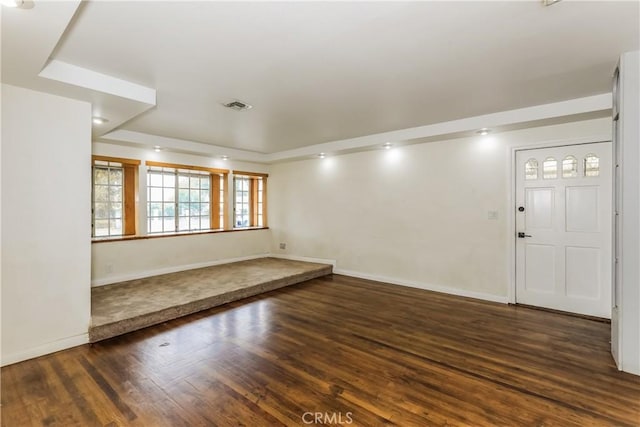 spare room featuring dark wood-type flooring