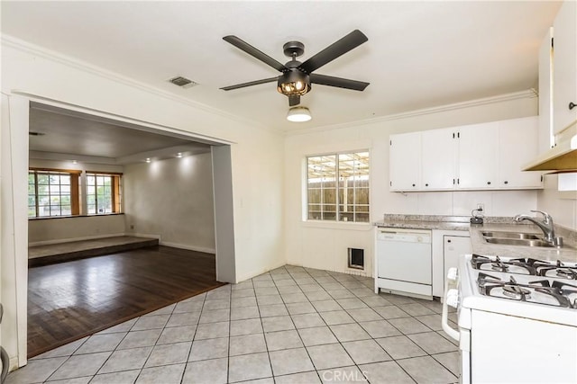 kitchen with light wood-type flooring, white appliances, a healthy amount of sunlight, and sink