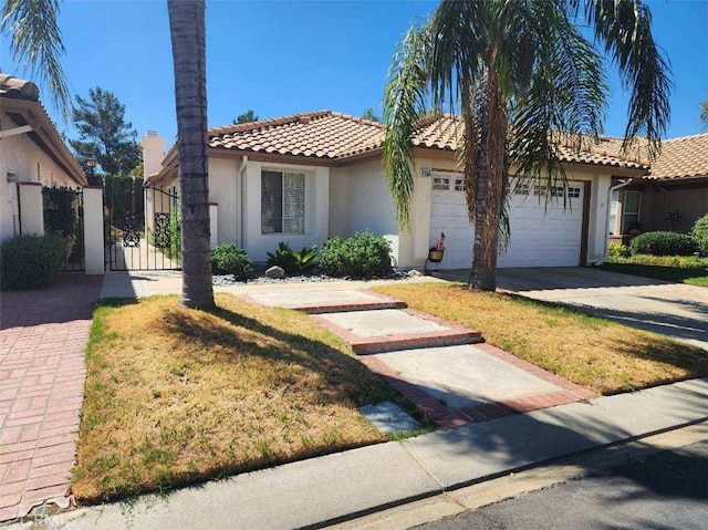 mediterranean / spanish-style house with a garage