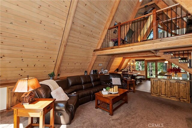 carpeted living room featuring wooden ceiling, wooden walls, beamed ceiling, and high vaulted ceiling