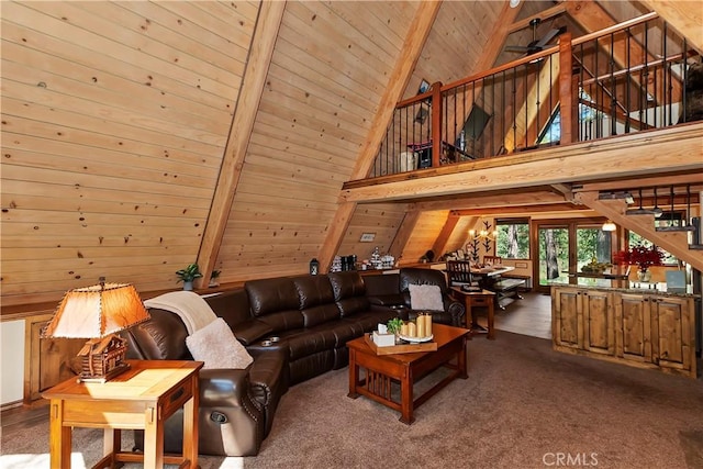 living area with high vaulted ceiling, wood walls, wood ceiling, stairs, and beamed ceiling