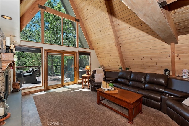 living area with wood ceiling, beamed ceiling, wood finished floors, a stone fireplace, and high vaulted ceiling