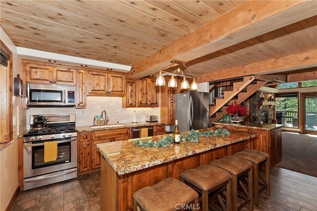 kitchen with beamed ceiling, sink, dark wood-type flooring, stainless steel appliances, and light stone countertops