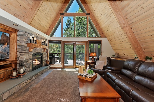 living room featuring a healthy amount of sunlight, wood ceiling, and a stone fireplace