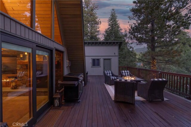 deck at dusk with an outdoor living space