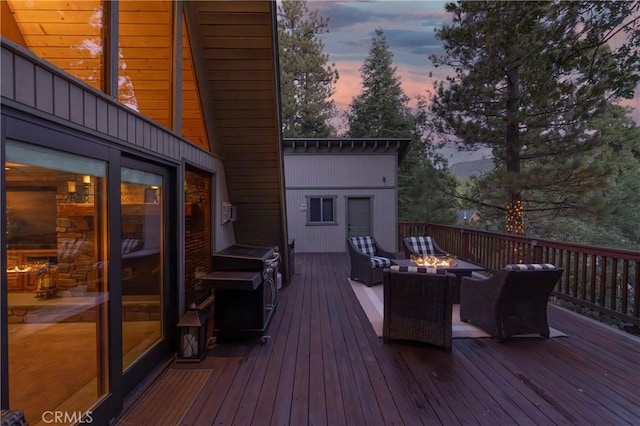 deck at dusk featuring an outdoor living space