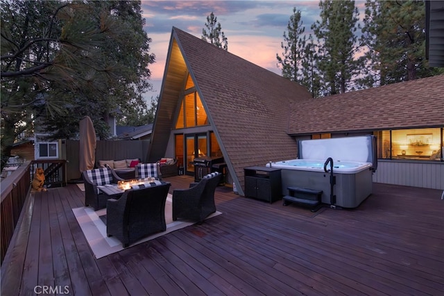 deck at dusk featuring outdoor lounge area and a hot tub