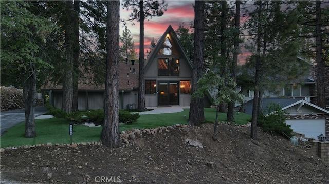 a-frame home with a lawn