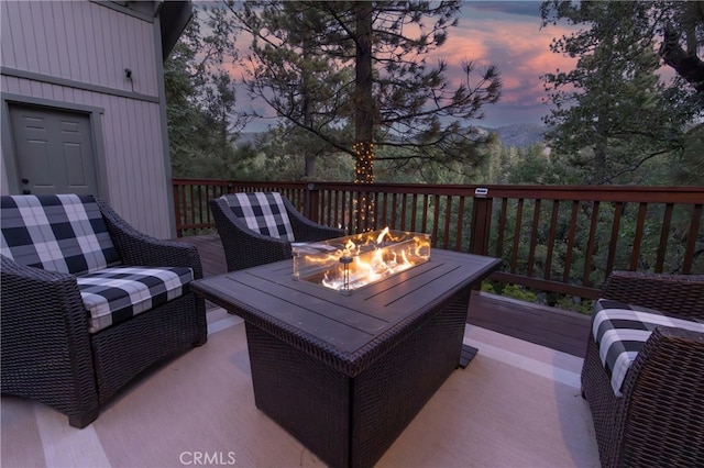 deck at dusk with an outdoor fire pit