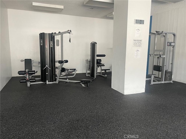 workout area featuring a textured ceiling