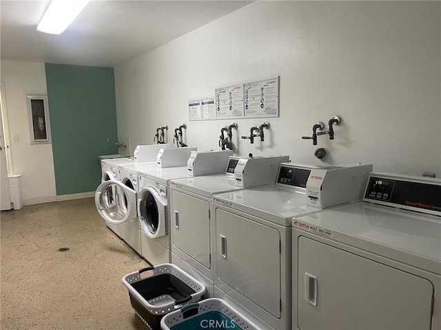 clothes washing area featuring washer and clothes dryer