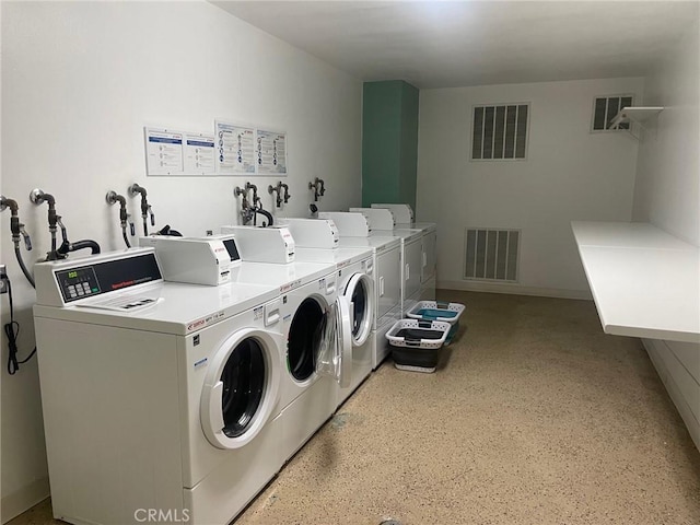 washroom with washing machine and clothes dryer