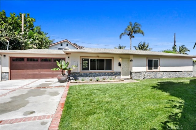 ranch-style house featuring a garage and a front lawn