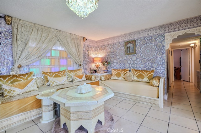 bedroom with light tile patterned flooring, a notable chandelier, and a textured ceiling