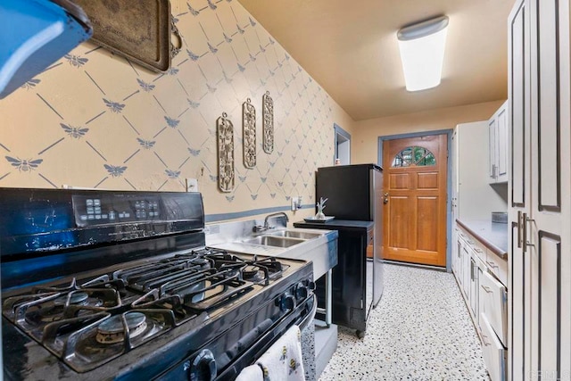 kitchen with gas stove and white cabinetry