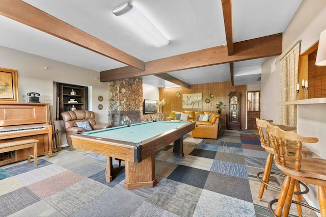 rec room with pool table, beamed ceiling, carpet flooring, wooden walls, and a fireplace