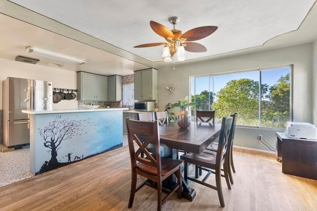 dining area featuring ceiling fan and light hardwood / wood-style flooring