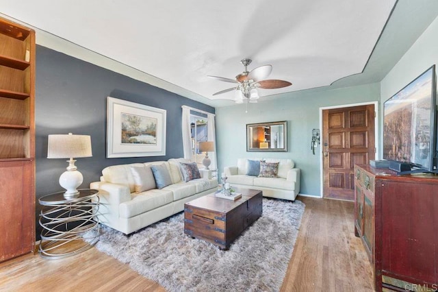 living room featuring ceiling fan and hardwood / wood-style floors