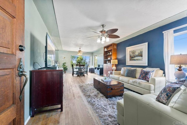 living room featuring light hardwood / wood-style flooring and ceiling fan