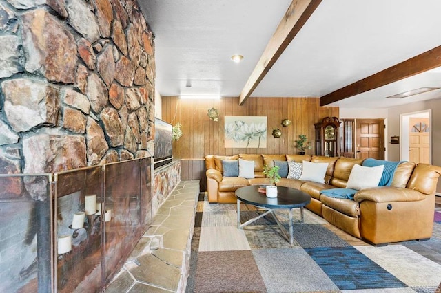 living room with beamed ceiling and wooden walls