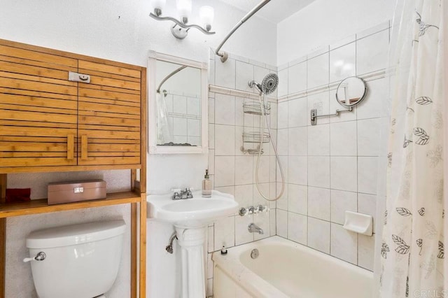 full bathroom with shower / bath combination with curtain, sink, and toilet