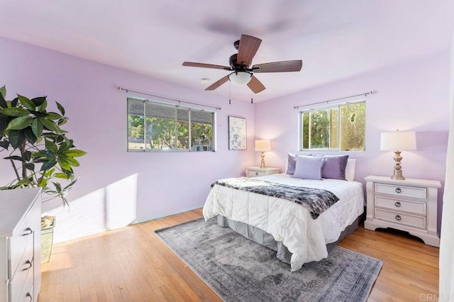 bedroom with light hardwood / wood-style flooring and ceiling fan