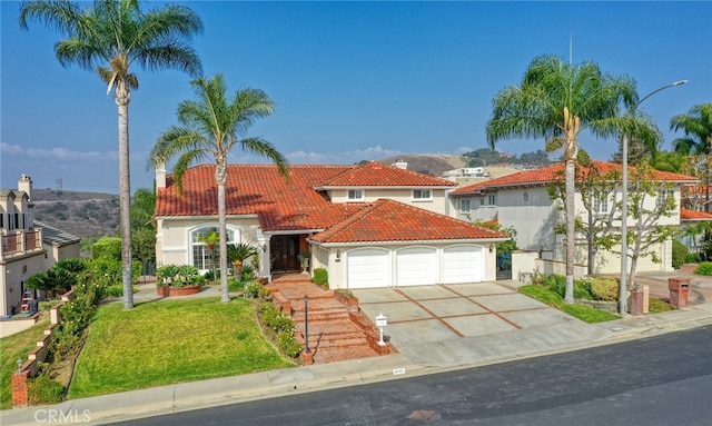 mediterranean / spanish home with a front yard