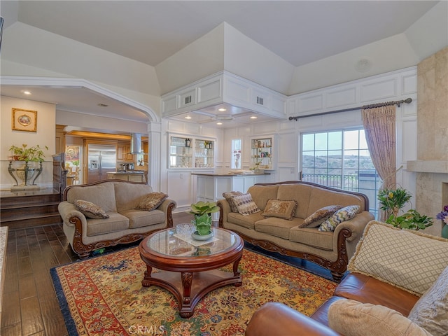 living room with a towering ceiling and hardwood / wood-style floors