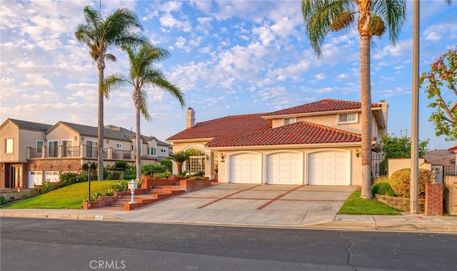 mediterranean / spanish home featuring a balcony, a front yard, and a garage