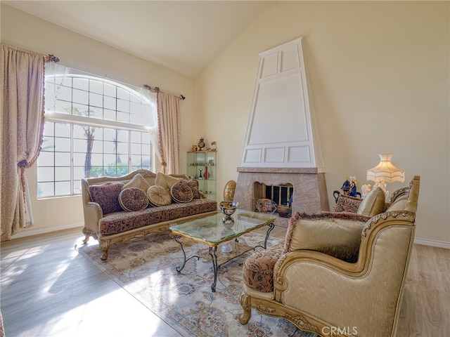 living room with light hardwood / wood-style flooring and vaulted ceiling