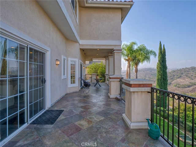 view of patio / terrace with a balcony and a mountain view