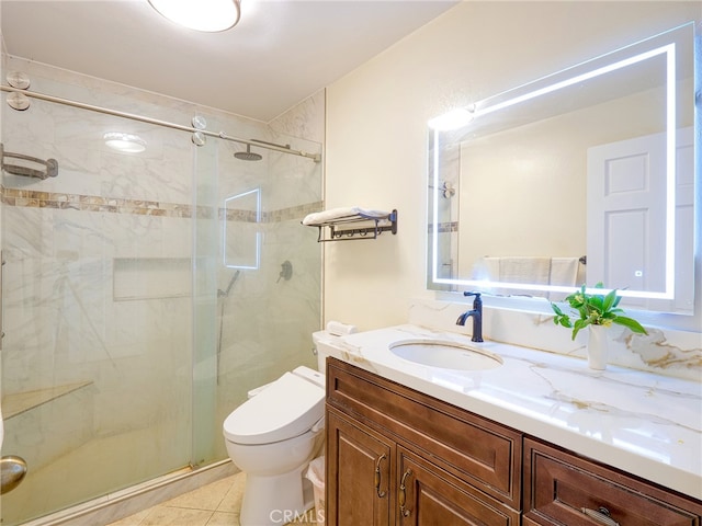 bathroom featuring walk in shower, vanity, toilet, and tile patterned floors