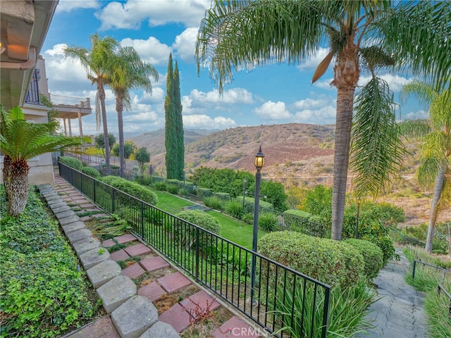 exterior space with a balcony and a mountain view